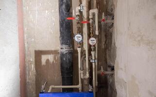 Water meters and polypropylene pipes for cold and hot water. Bypass and taps for heated towel rail. Copy space for text photo