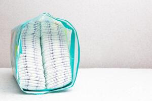 A whole package of baby diapers on a white background. Copy space for text photo