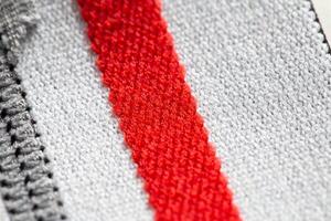 Fabric with white and red stripes, background. Macro, texture photo