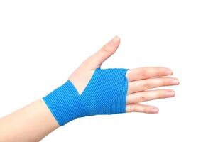 Blue elastic bandage on the wrist joint of the hand on a white background, isolate. Concept of wrist fixation in case of dislocation and contusion, compression photo
