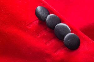 Red stylish jacket with buttons, background. Stylish clothes, macro, elegant photo