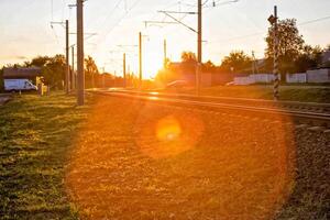 railway and railway crossing on the background of a sunny sunset, background. Copy space for text photo