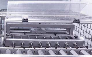 Making and filling custard cakes with cream on a modern automatic line, production of confectionery sweets photo