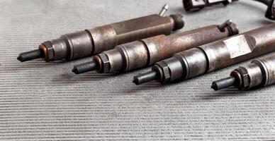 Mechanical injectors from a diesel engine, close-up. Fuel atomization, diesel fuel quality. Close-up, copy space for text photo