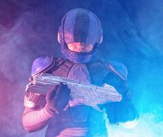 Cyberpunk future concept. Police officer reloads futuristic shotgun in dark. Robot aims at camera. Halfman bionic cyborg releases disconnector assembly of gun. Science fiction scene, fantasy, sci photo