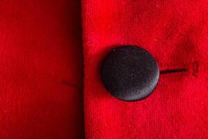 Red stylish jacket with buttons, background. Stylish clothes, macro, elegant photo