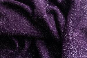 purple sweater with sequins, background, macro. Texture photo