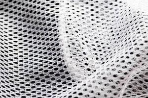 White lining in clothes in a hole, macro. Textured photo