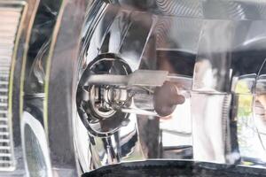 Halogen bulb in headlight with reflector of a passenger car, macro photo