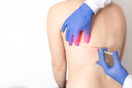 The doctor makes an injection with a medication blockade into the intercostal space in case of intercostal neuralgia. Pain in the ribs and side, copy space for text photo