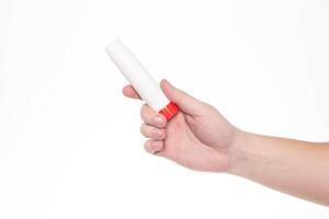 Man holds a glue stick in his hand on a white background, isolate. Close-up photo