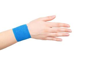 Blue elastic bandage on the wrist joint of the hand on a white background, isolate. Concept of wrist fixation in case of dislocation and contusion, compression photo