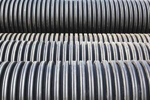 Modern polypropylene pipes for conducting heating mains underground. Durable and anticorrosive properties of water pipes, drainage system photo