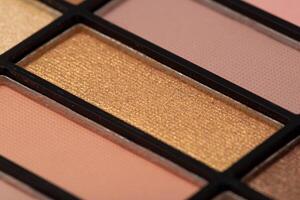 A set of modern eye shadows with powdery shades on a blue background. Soft texture and shading, brand, close-up. photo