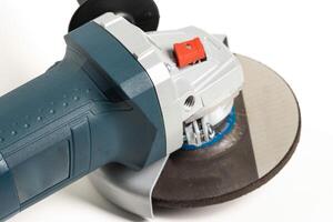 Modern angle grinder with red spindle lock button. Close-up, smooth start. photo