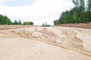 The construction of a wide road and sidewalk. Marking in the sand for a new footpath, background, copy space photo
