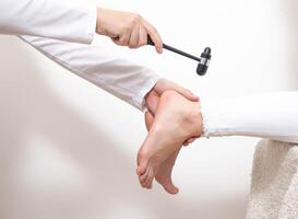 Checking the patient's Achilles reflex for the presence of a compressed nerve with injuries of the spine and spinal cord of an intervertebral hernia, copy space photo