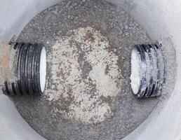 Construction of sewage engineering structures for the drain of sanitary water and rainwater, industry. Plastic pipes in the sewage system in reinforced concrete rings, sewer network photo
