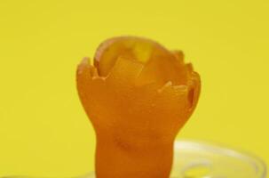 Low-quality torn baby silicone pacifier on a yellow background, close-up. Concept of the anatomical shape of the pacifier, teething in children. photo