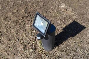 Outdoor diode floodlight with motion and light sensor, modern. Illuminated photo