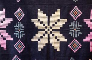 Traditional rustic tablecloth with handmade patterns and embroidery, macro photo