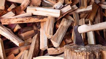 Ax on the background of firewood in the village, copy space for text. Hardwood photo