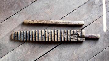 Household item was used for knocking out washing and ironing clothes. The hand-wrung linen was wound on a roller or rolling pin and rolled out with a ruber. Ancient thing photo
