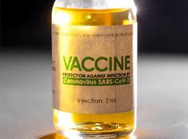 Vial with coronavirus vaccine on a black background, close-up. Vaccine development and research concept photo