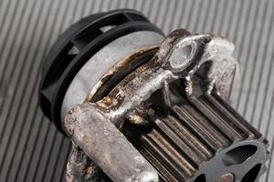 Old leaky car pump. Breakdown of the car pump in the cooling system, macro photo