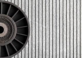 Old dirty car roller made of plastic and bearing on a gray background. Copy space for text photo