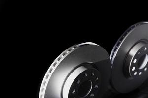White brake discs on a black background. Efficient braking, safety. Copy space for text photo