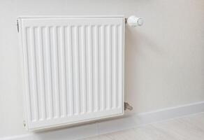 Modern wall mounted heating radiator in the room. Comfortable temperature in the apartment in winter. heating price. Copy space for text photo