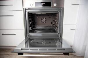Modern electric oven with telescopic rails, top and bottom heat. Function 3D hot air, thermal grill and convection. Automatic cooking photo
