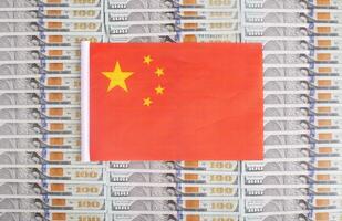China flag on a background from dollar banknotes. Concept of the relationship of the money of china in relation to the dollar, the country's economy, financial photo