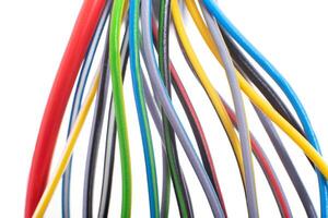 A lot of multi-colored electric wires on a white background. Solid wire with color insulation marked plus and minus, anti-short circuit, macro photo