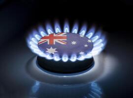 Burning gas burner of a home stove in the middle of which is the flag of the country of Australia. Gas import and export delivery concept, price per cubic meter, transit, background photo