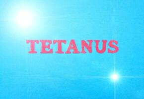 Word tetanus in red letters on a blue background. The concept of a deadly disease of the neural system with convulsions. Treatment and vaccination against tetanus, therapy photo