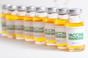 Vials of coronavirus medicine on a white background. Vaccination of the population from covid19, macro photo