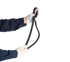 A car mechanic holds a used alternator rivulent belt on a white background, isolate. Background photo