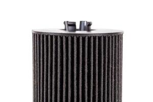 Car oil filter insert on white background, isolate. The concept of cleaning oil from dirt and impurities. Close-up photo