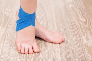 Elastic bandage on the ankle of the leg. Joint fixation concept with a bandage, copy space for text photo
