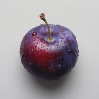 A purple and red apple with drops of water on it, suggesting recent rainfall. photo