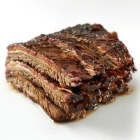 Delicious looking barbecue ribs stacked neatly on a white plate. photo