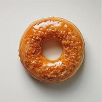 A round glazed donut with a single hole in the center. photo
