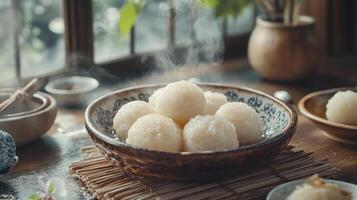 Steam rising over a bowl of rice soaks on a bamboo mat, surrounded by various spices and ingredients. photo