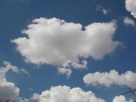 A large white cloud on clear blue skies photo