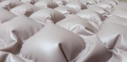A close-up view of a textured, plush mattress with stylized cube patterns, showcasing its soft and inviting design, ideal for enhancing comfort while sleeping in any bedroom photo