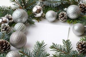 Christmas frame with blank copy white space in the center for text and messages decorated with silver Christmas decorations, balls, bling and evergreen pine branches photo