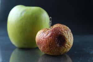 apple ugly spoiled and beautiful good on a black background copyspace photo