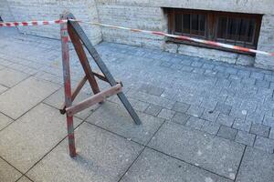 red white fencing tape. Allocation of the hazardous zone of the construction site photo